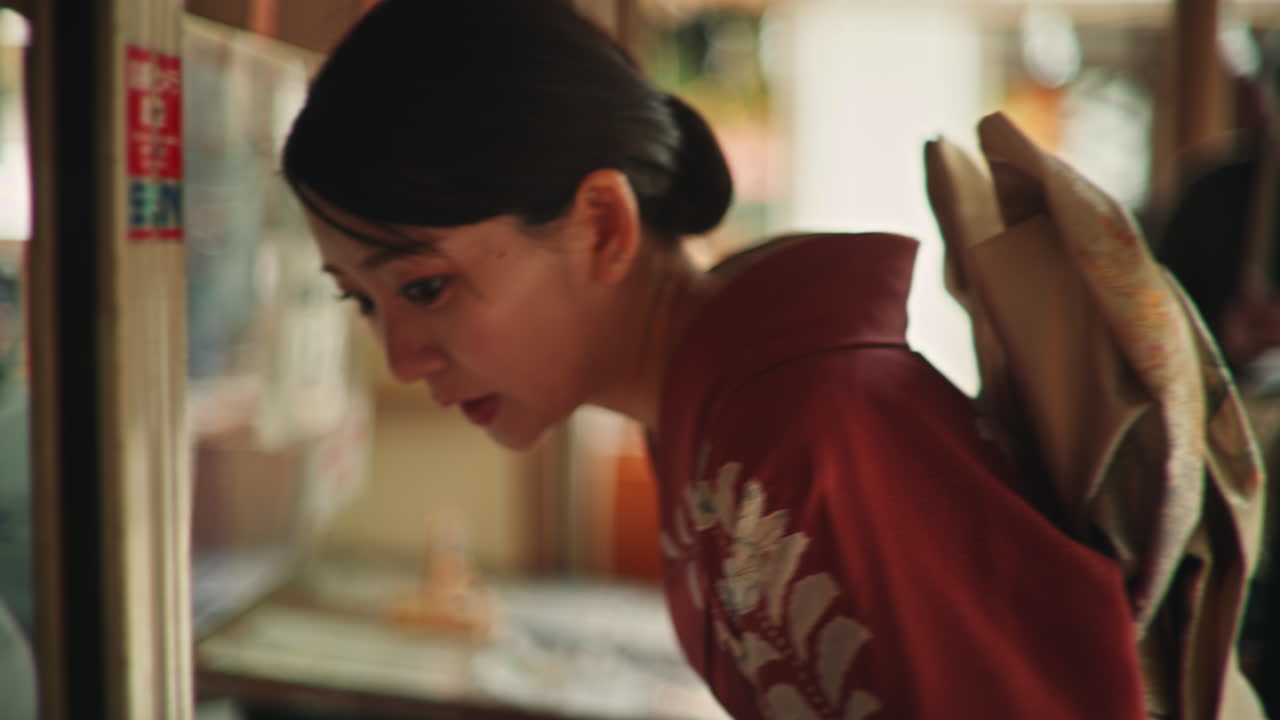 Woman in Kimono Looking at Display Case