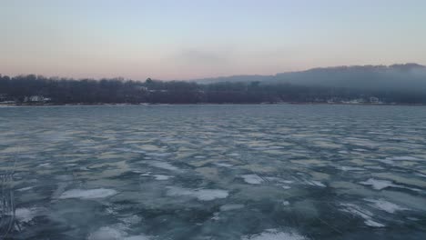 frozen lake at sunrise/sunset with houses