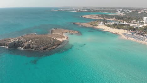 clear blue sea water at nissi beach - aerial view