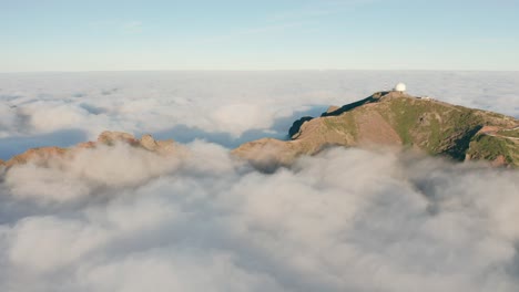 aerial of low hanging clouds covering part of idyllic madeira island