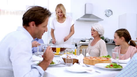 Woman-serving-salad-at-dinner