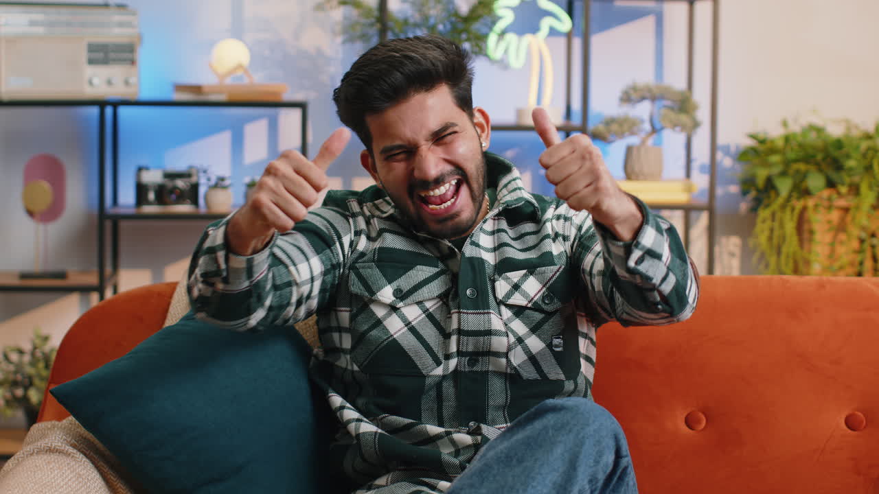 Excited happy indian man surprised shocked by sudden victory good win news celebrating wow reaction