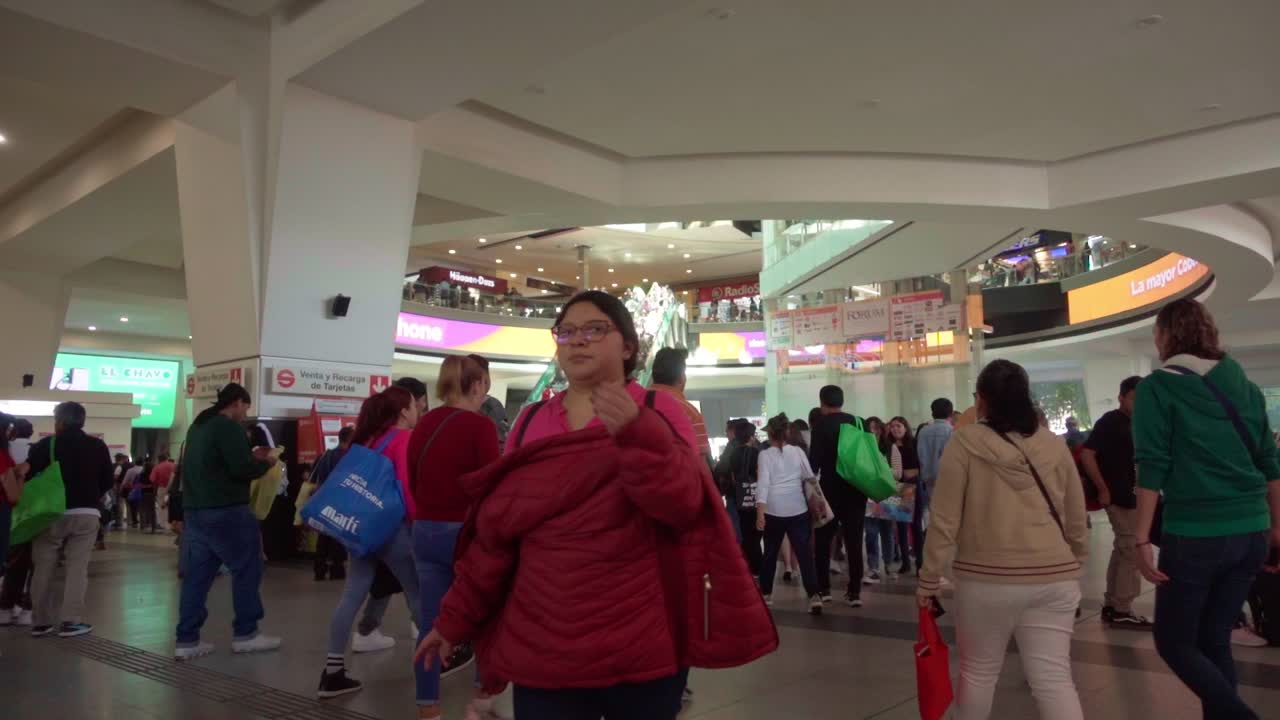 Commuters passing by in train station of Buena Vista, CDMX. Slow motion