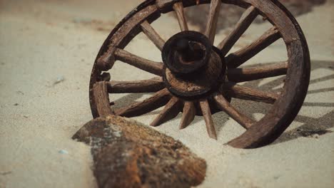 Large-wooden-wheel-in-the-sand