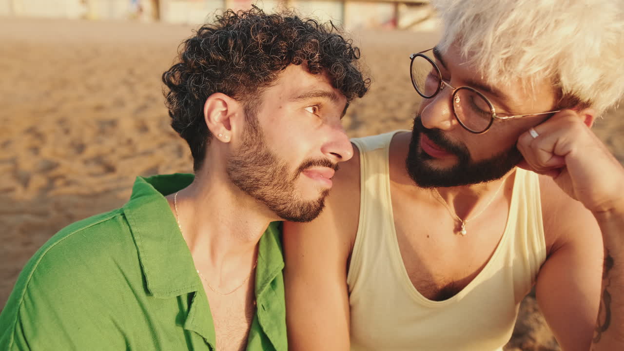 Happy Gay Couple Sharing an Intimate Moment on the Beach at Sunset