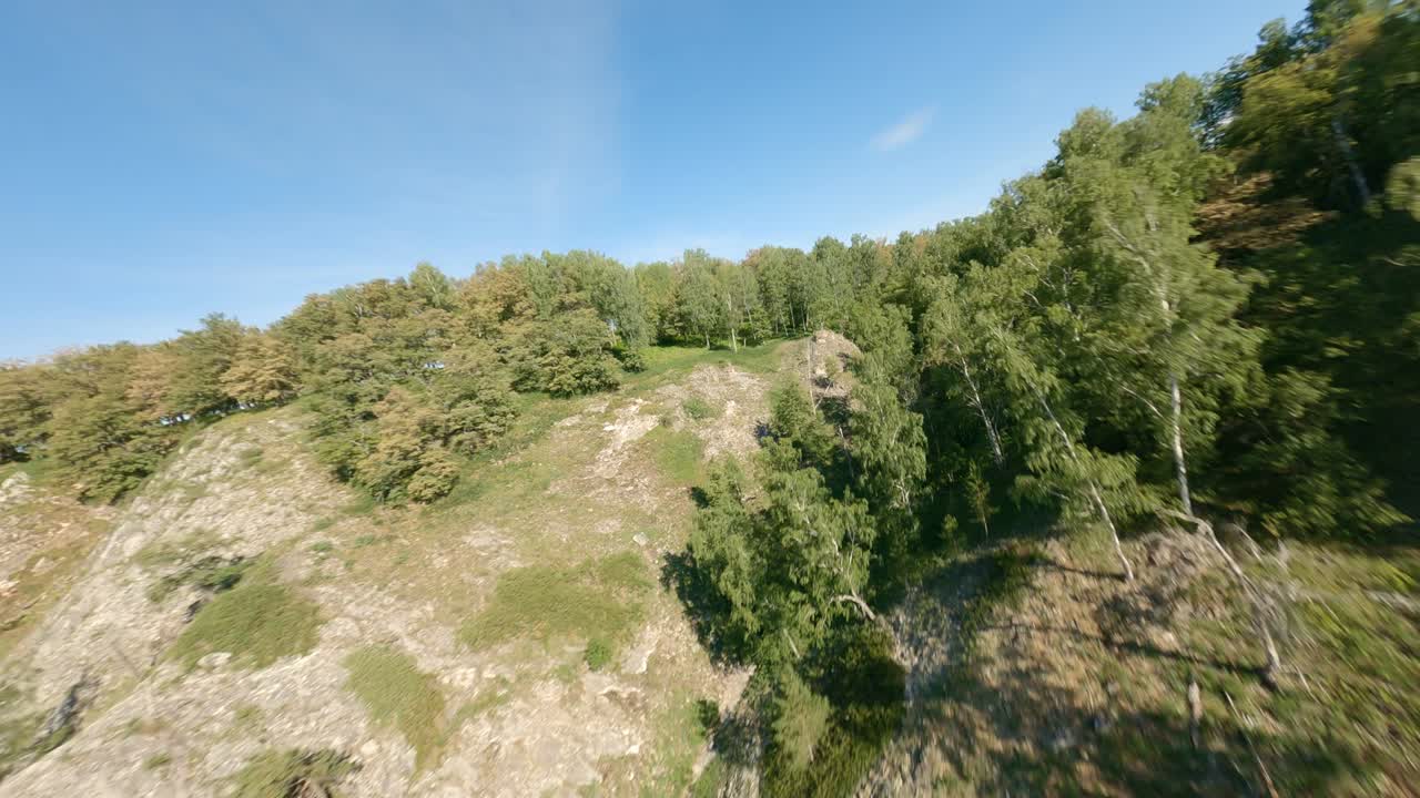 View from above on mountain ranges and plateaus. The vast area of the mountain slope is occupied by deciduous forests. A beautiful view of the valley which crosses the river. Nature.