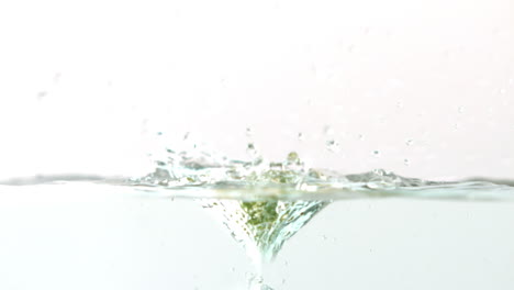 Kiwi-falling-in-water-on-white-background