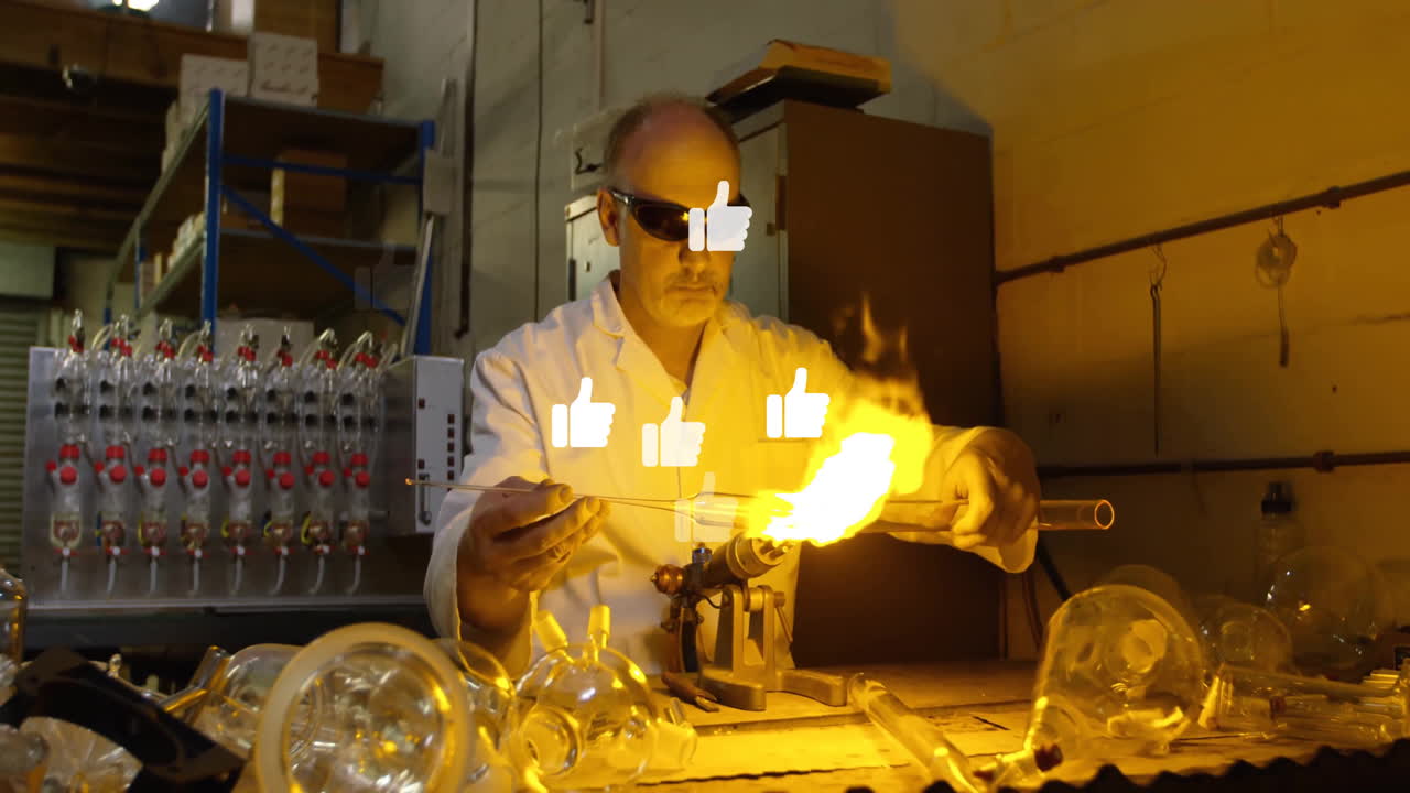 In school lab, scientist wearing safety glasses working with flames and animation