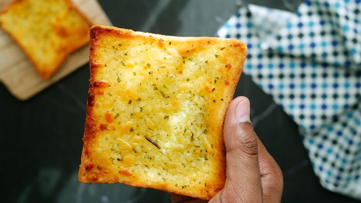 Garlic bread on a plate on table ,