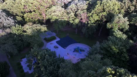 A-high-angle,-aerial-view-of-a-park-playground-in-the-suburbs-of-Valley-Stream,-NY-on-a-sunny-day