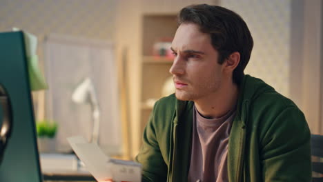 serious man looking computer screen at office close up. creator using pc device