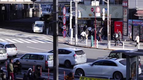 pedestrians and vehicles crossing an urban intersection.