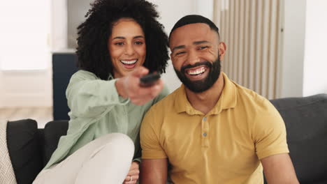 Happy-black-couple,-relax-and-watching-tv-on-sofa