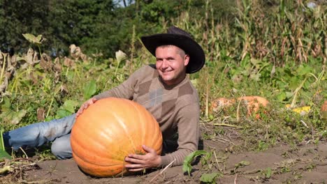 a farmer hugs a pumpkin in the garden farming and agriculture a farmer hugs a pumpkin in the garden autumn scene ecological health concept fresh products farming and agriculture