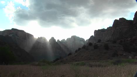 Long-Shot-Of-Rays-Of-Sunlight-Filtering-Over-Mountain-Peaks-In-Zion-National-Park-1