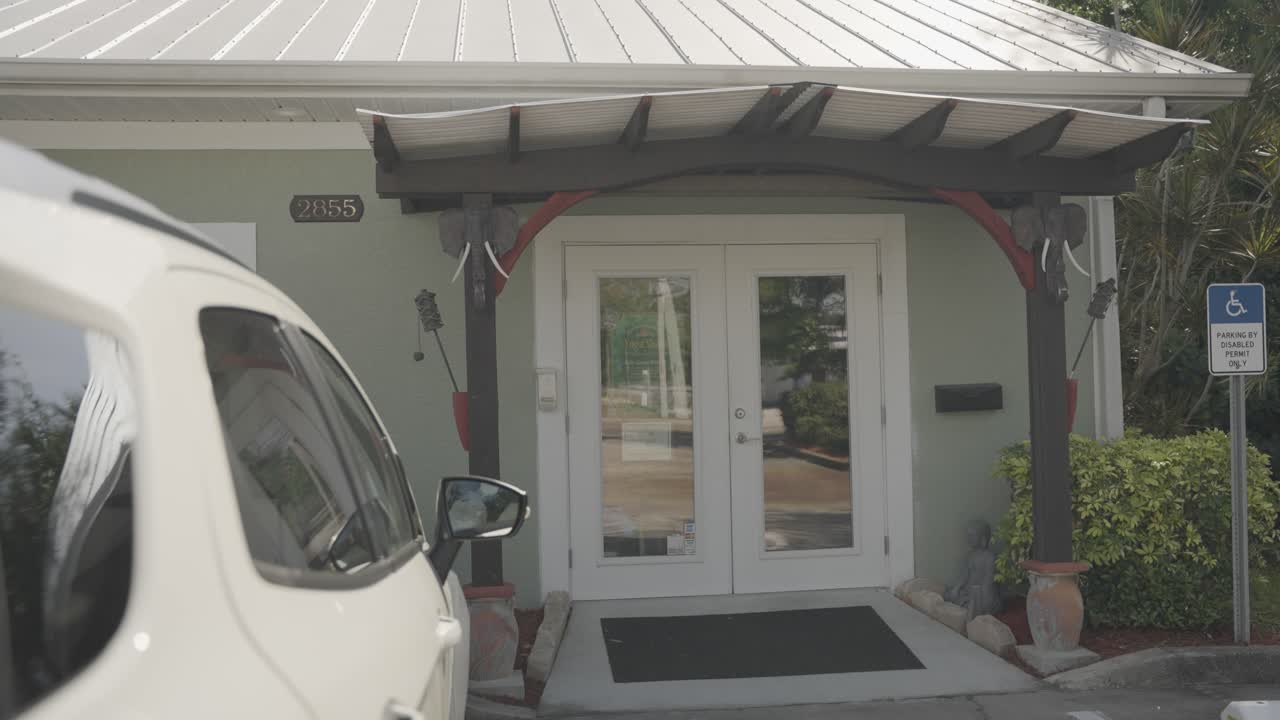 Stunning sight of a residence's entrance featuring a ramp for disabled access above a parked vehicle.