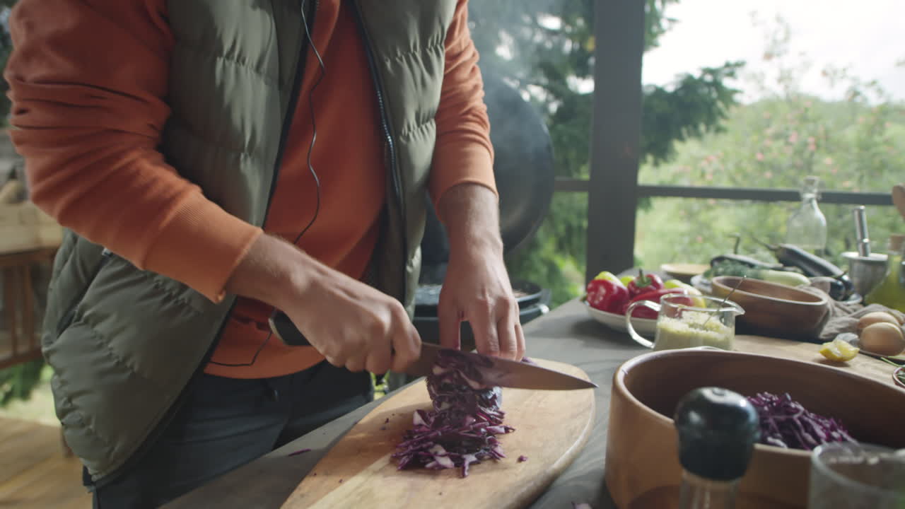 Man Cutting Red Cabbage on Barbeque Terrace