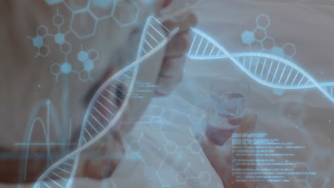 dna strands and hexagonal patterns animation over person holding glass