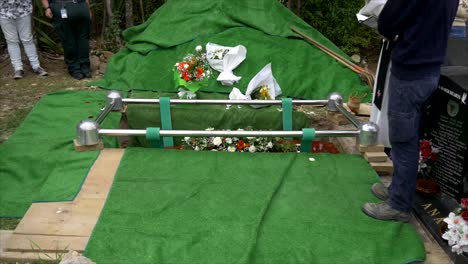 closeup shot of a funeral casket or coffin in a hearse or chapel or burial at cemetery