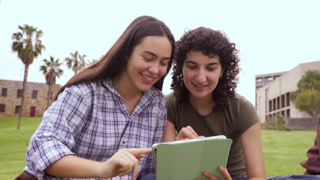 cheerful friends using tablet computer