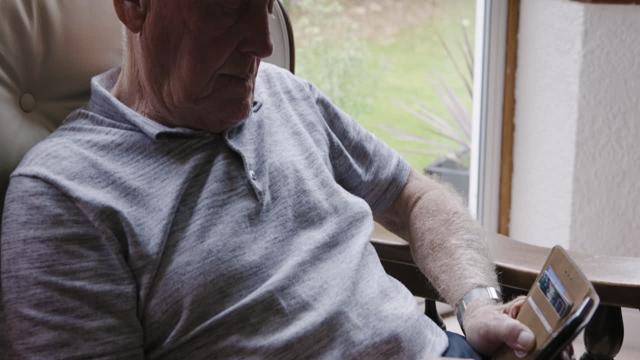 Elderly man relaxing in armchair