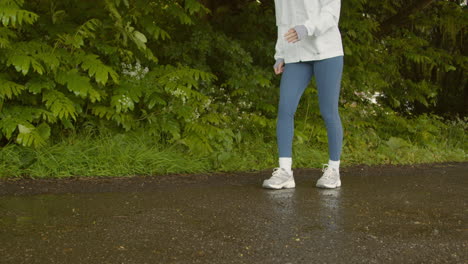 close up of woman legs as she exercises keeping fit running in rain