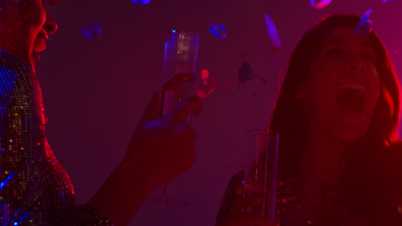 Close Up Of Two Women In Nightclub Bar Or Disco Dancing And Drinking Alcohol With Paper Confetti 1