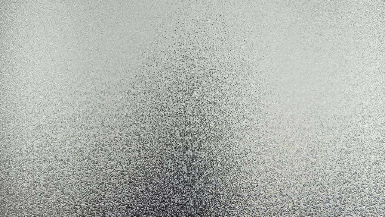 A female silhouette behind the frosted glass moves slowly and screems