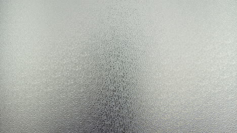 a female silhouette behind the frosted glass moves slowly and screems