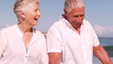 Mature-couple-walking-and-holding-hands