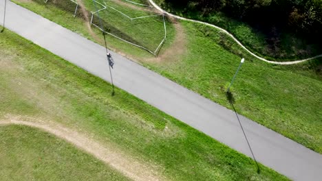 Cyclist-riding-through-London-park