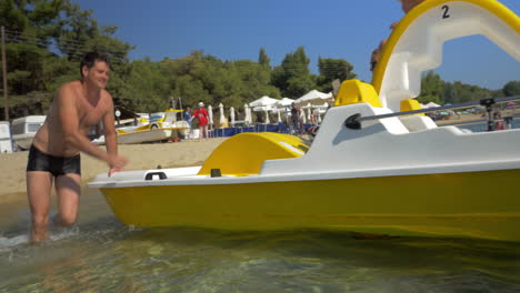 family having sea ride on pedal boat