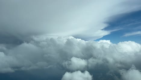 COCKPIT-VIEW---Mesmerising-pilot-view-flying-towards-stormy-clouds,-high-altitude