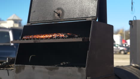 bbq rack of ribs in a smoker sizzling