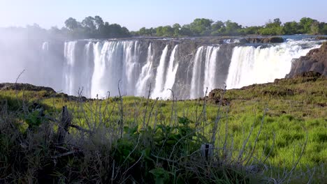 victoria falls with green vegetation in foreground from the zimbabwe side of the african waterfall 1