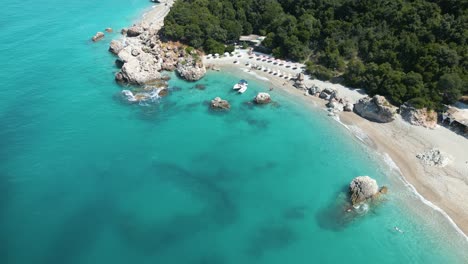 Drone-descends-down-to-tropical-white-sandy-beach-of-the-Albanian-Riviera