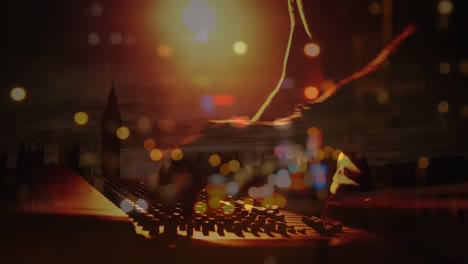 animation of blured road traffic over hand of caucasian male dj and console