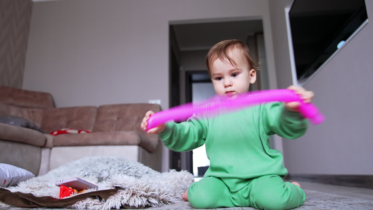Baby Playing with Pink Toy