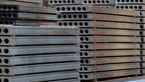 big piles of armored concrete plates for construction with holes inside. building materials storage at modern plant.