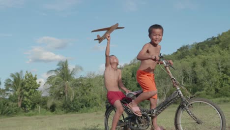 children playing on a bike with a paper plane