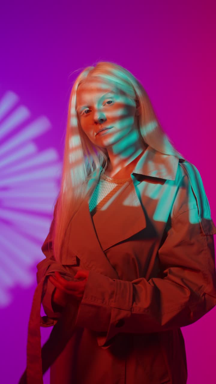 Fashionable Woman in Trench Coat with Colorful Lighting