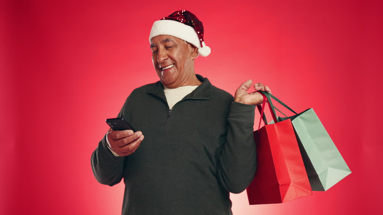 Man in Santa hat doing Christmas shopping on his smartphone