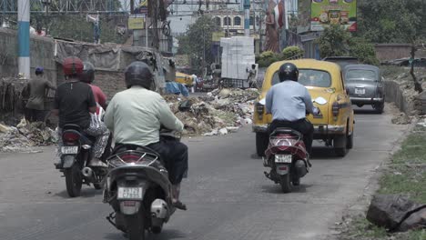 street scene with taxis and motorcycles