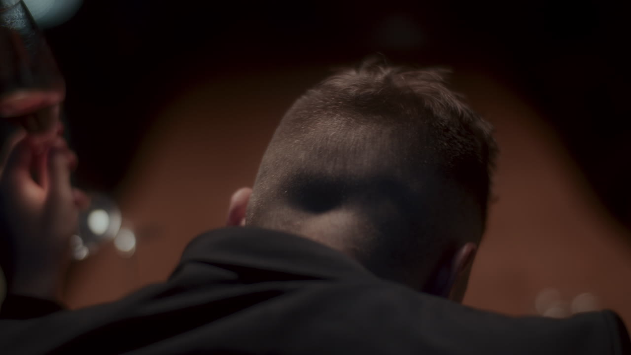 Man from behind in a dark room