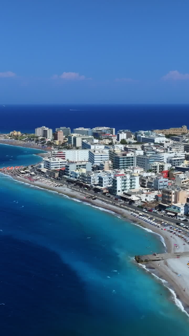 Vertical drone shot backwards in front of Rhodes city, sunny day in Greece