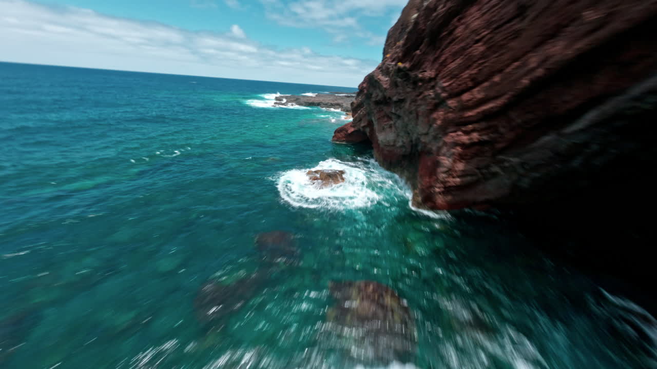 FPV drone view of rocky coastline at La Fajana, dramatic and thrilling