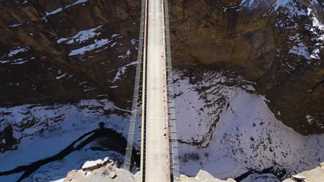 drone fly above asia's highest chicham bridge in spiti himachal pradesh india with snow mountains himalayan landscape