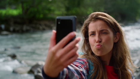 joyful woman taking selfie on mobile phone