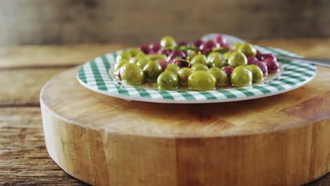 plate of pickled olives and herbs