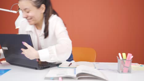 woman joyfully embracing laptop.